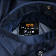The Alpha Industries Tag on the Detroit Tigers MLB Patch Alpha Industries Reversible Bomber Jacket With Camo Liner | Navy Blue Bomber Jacket