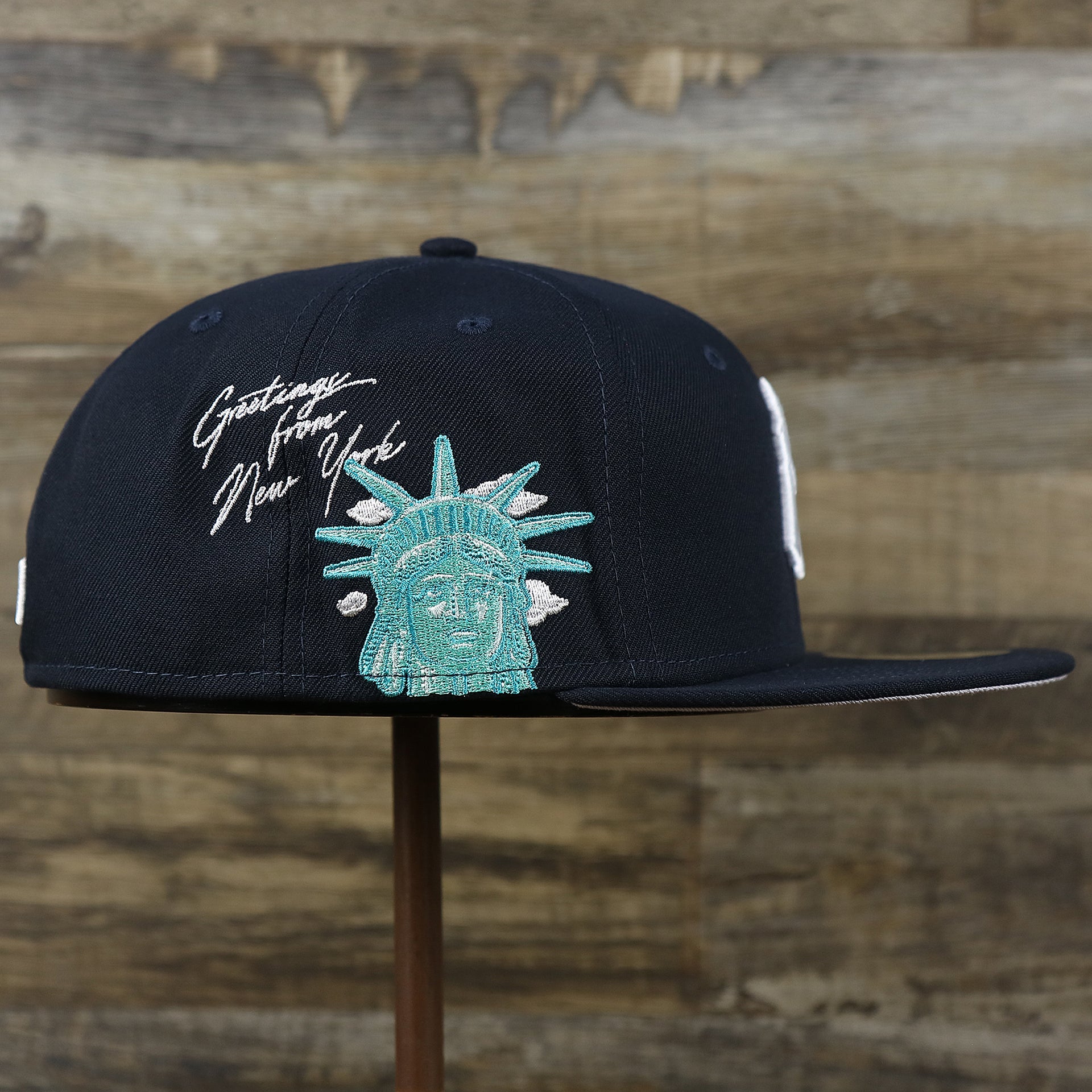 The wearer's right on the New York Yankees Lady Liberty Side Patch Gray Bottom 59Fifty Fitted Cap | Navy Blue 59Fifty Cap