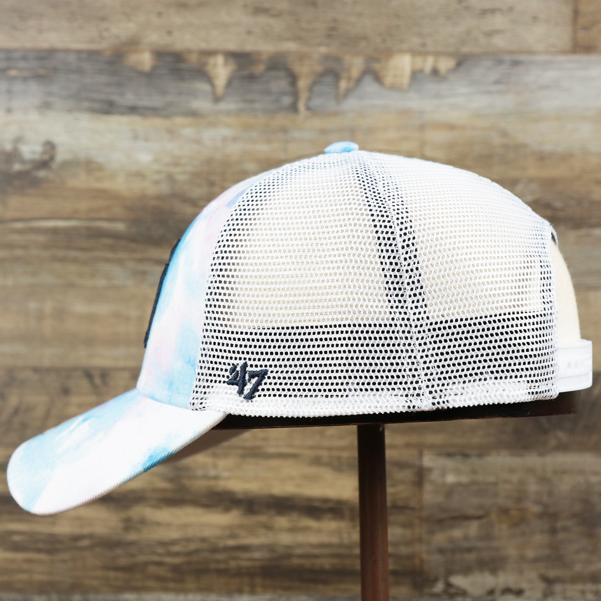 The wearer's left of the Women’s New York Yankees Tie Dye Print Gray Bottom Mesh Trucker Hat | White Mesh Snapback