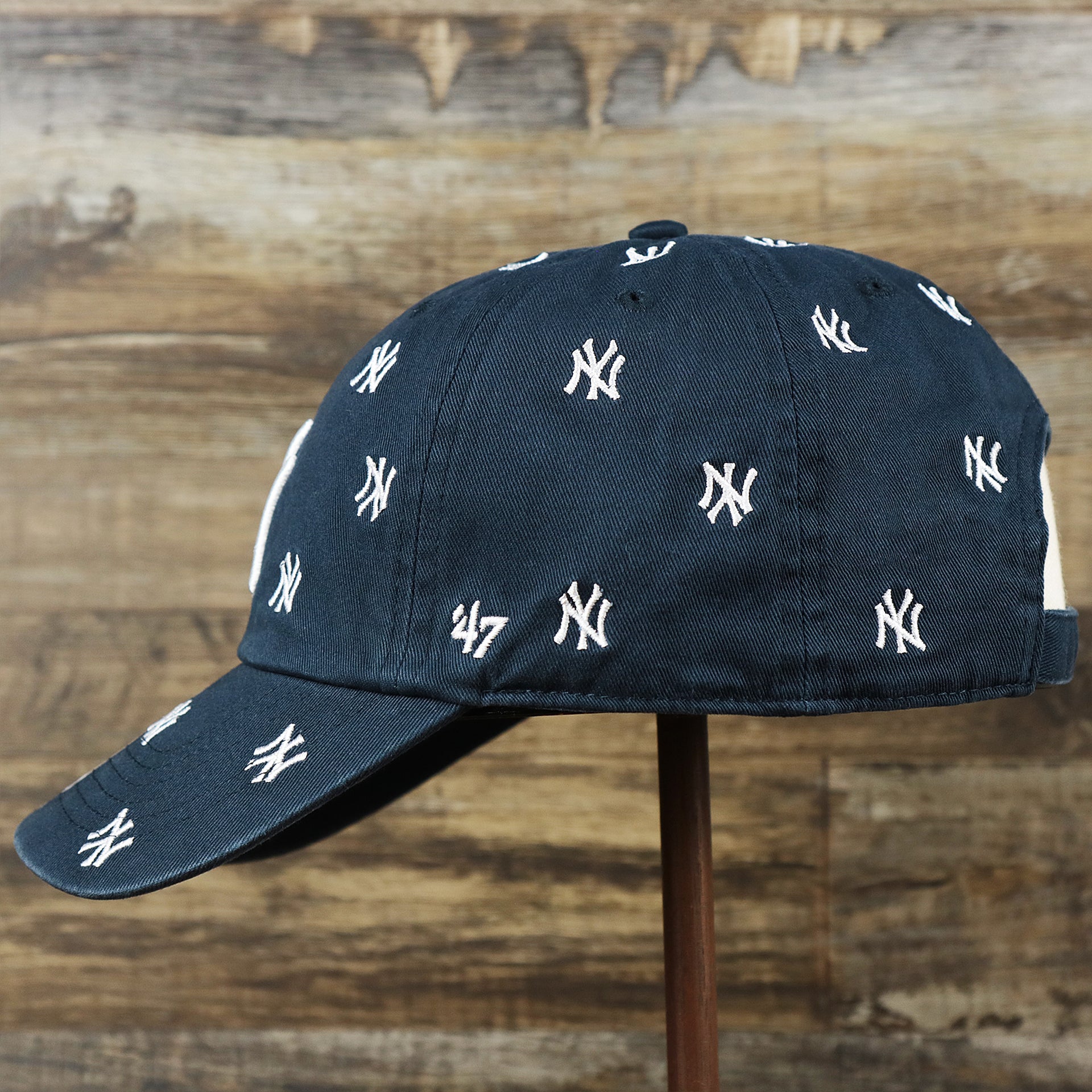 The wearer's left on the Women’s New York Yankees All Over Yankees Logo Dad Hat | Navy Women’s Dad Hat