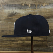 The wearer's left on the New York Yankees Gray Bottom Wool 59Fifty Fitted Cap | Navy Blue 59Fifty Cap