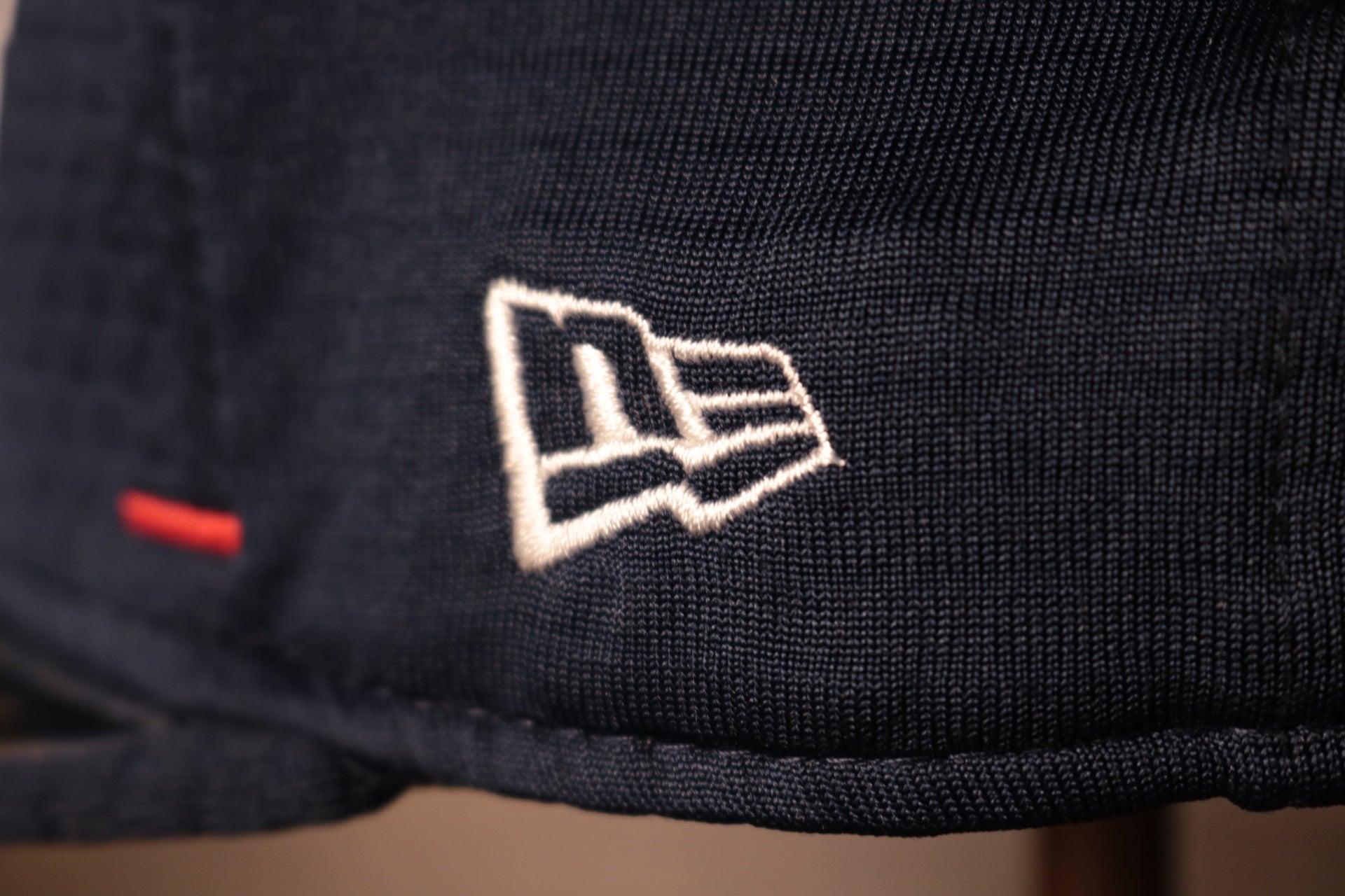 The new era logo is in white Patriots 2020 Training Camp Snapback Hat | New England Patriots 2020 On-Field Navy Training Camp Snap Cap