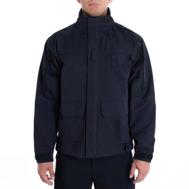 a police officer wears the Police Public Safety | Tactical Shell Jacket with Stow-Away Hood | Dark Navy Scotchlite Tacshell Jacket