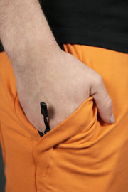 One of the two zipped pockets of the orange Jordan Craig french terry shorts.