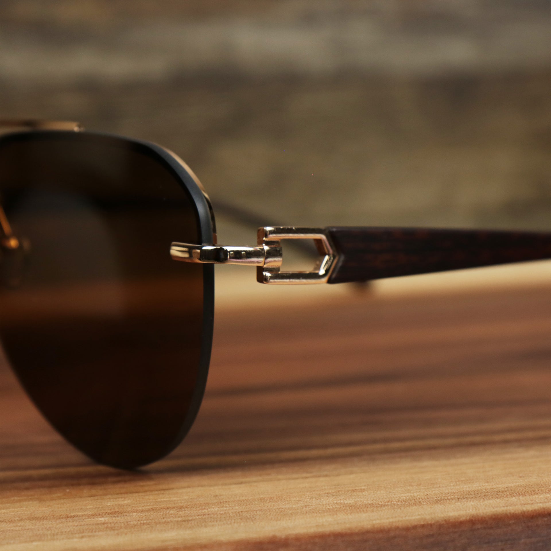 The hinge on the Round Aviator Frames Brown Lens Sunglasses with Gold Frame