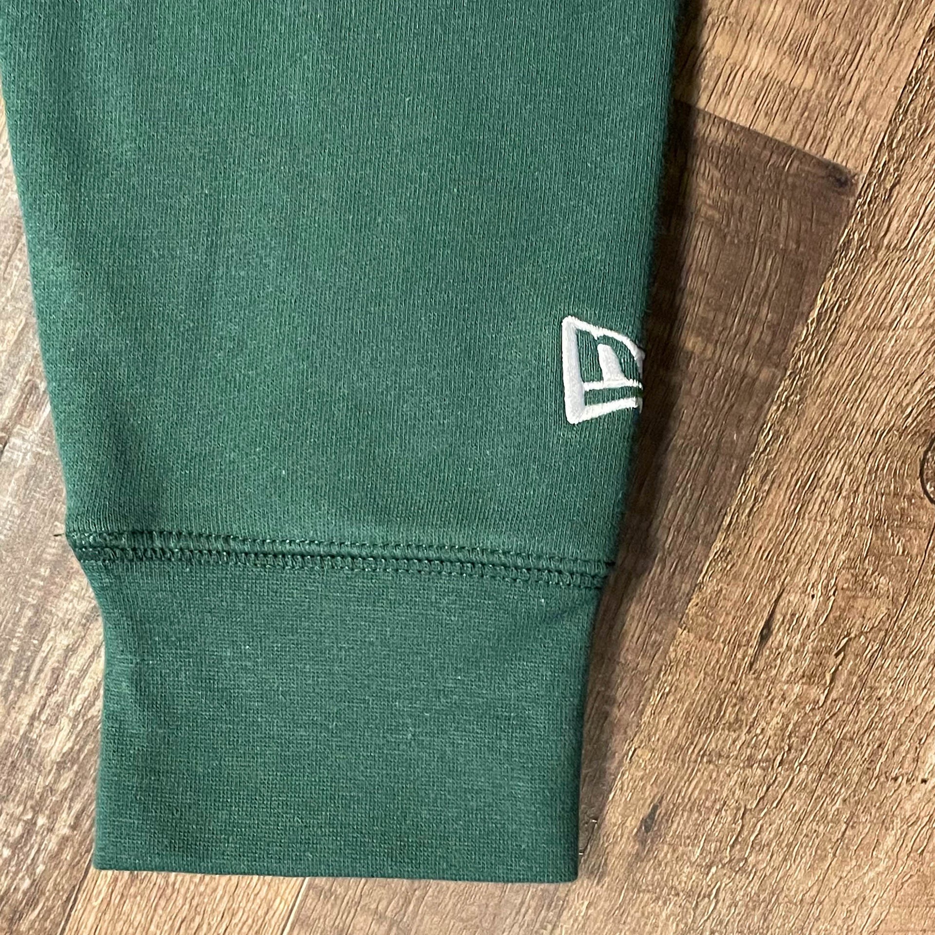 Close up of the New Era flag embroidered on the Oakland Athletics "City Cluster" 59Fifty Fitted Matching Green Pullover Hoodie