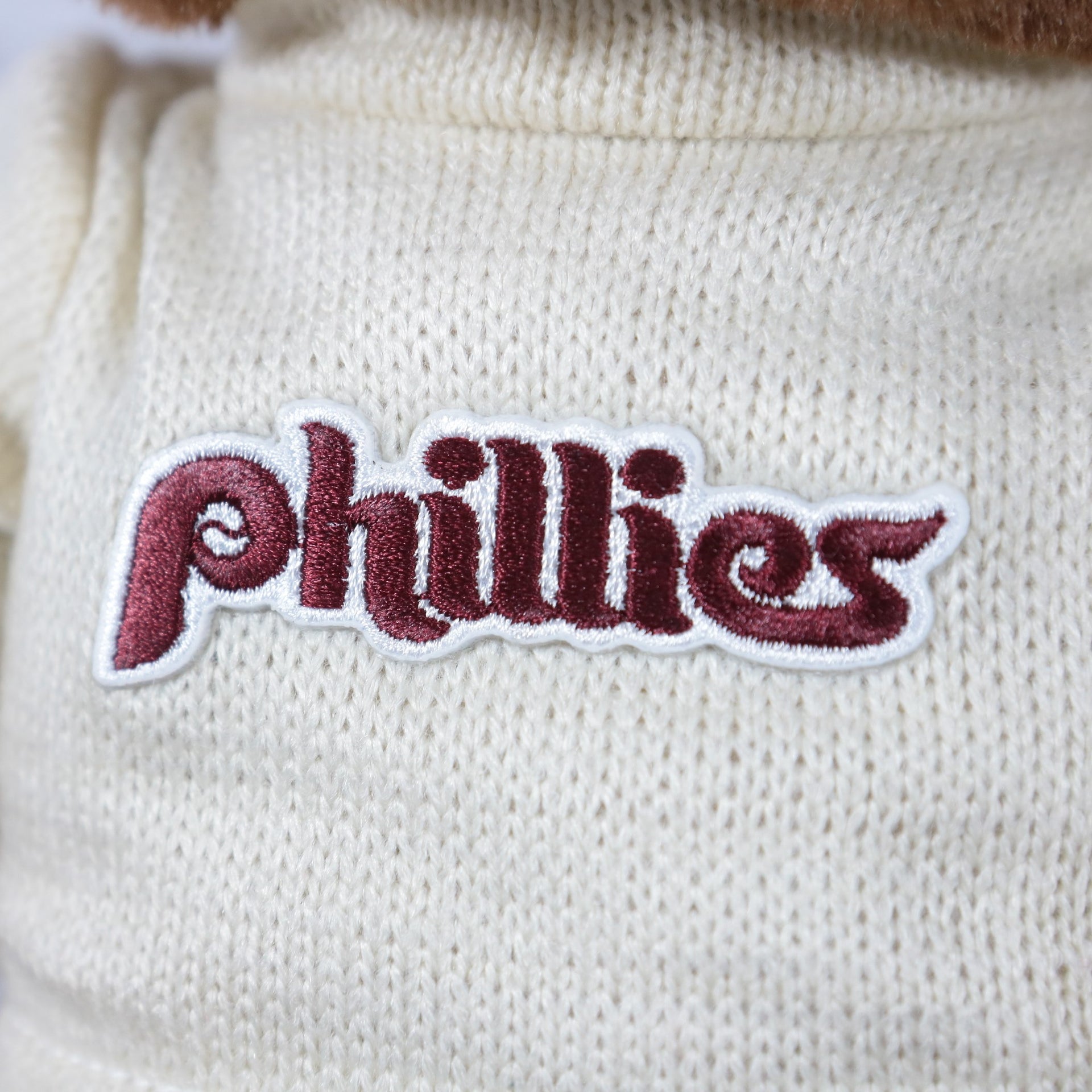 phillies wordmark on the Philadelphia Phillies Fuzzy Wuzzy "Phillies" Cooperstown wordmark Cream Sweater | Dark Brown Teddy Bear