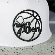 76ers logo on the Philadelphia 76ers Cement Top Black Bottom 2-Tone | White/Silver Snapback Hat