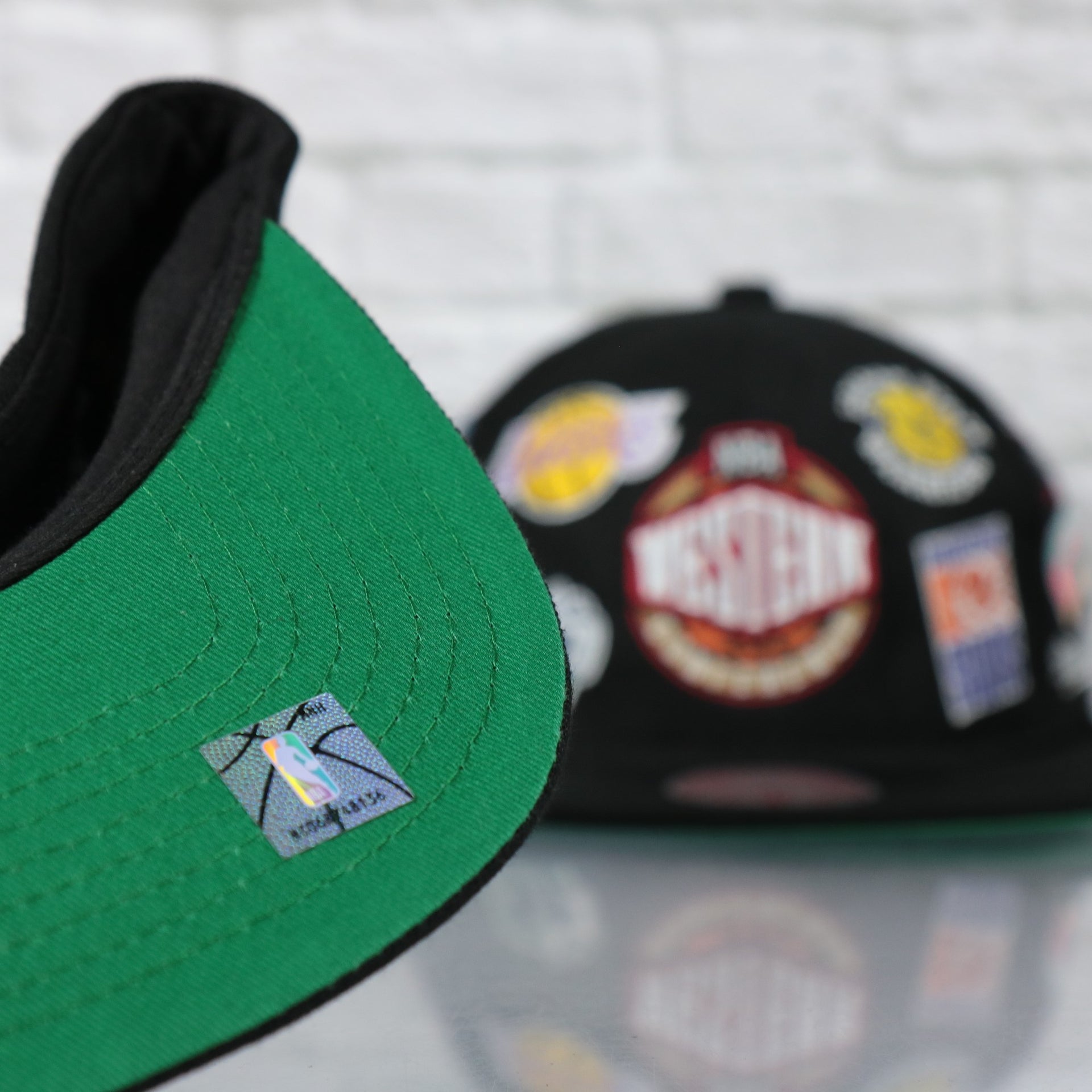 green under visor on the NBA West All Over Conference Hardwood Classics Deadstock Green bottom | Black Snapback Hat