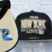 cream bottom on the New York Rangers With Love 75th Anniversary Side Patch Cream Bottom | Black Snapback Hat