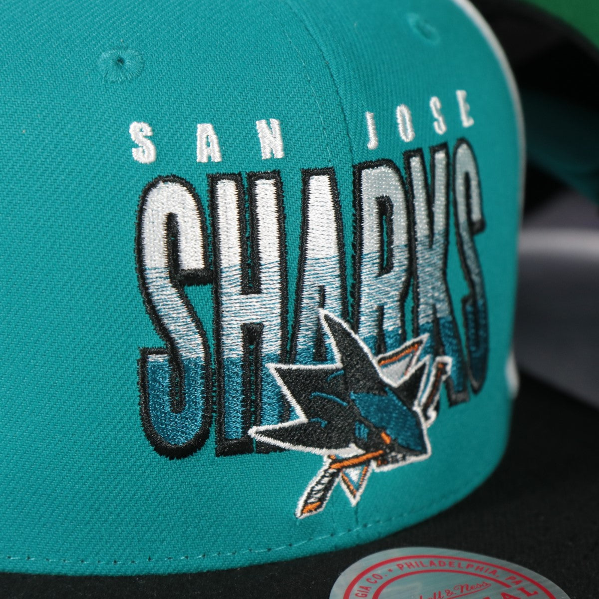 sharks logo on the San Jose Sharks NHL Billboard 2 Green bottom Tri-Tone | Teal/White/Black Snapback Hat