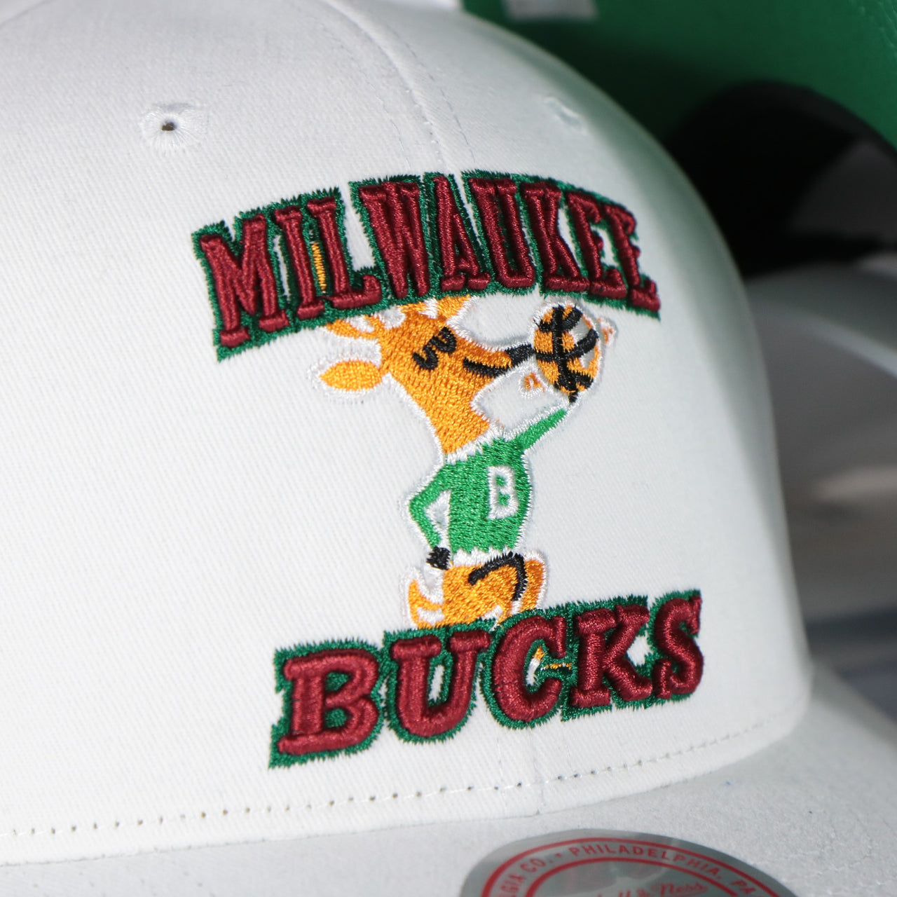 bucks logo on the Milwaukee Bucks NBA Hardwood Classics All in Pro Green Bottom | White Snapback Hat