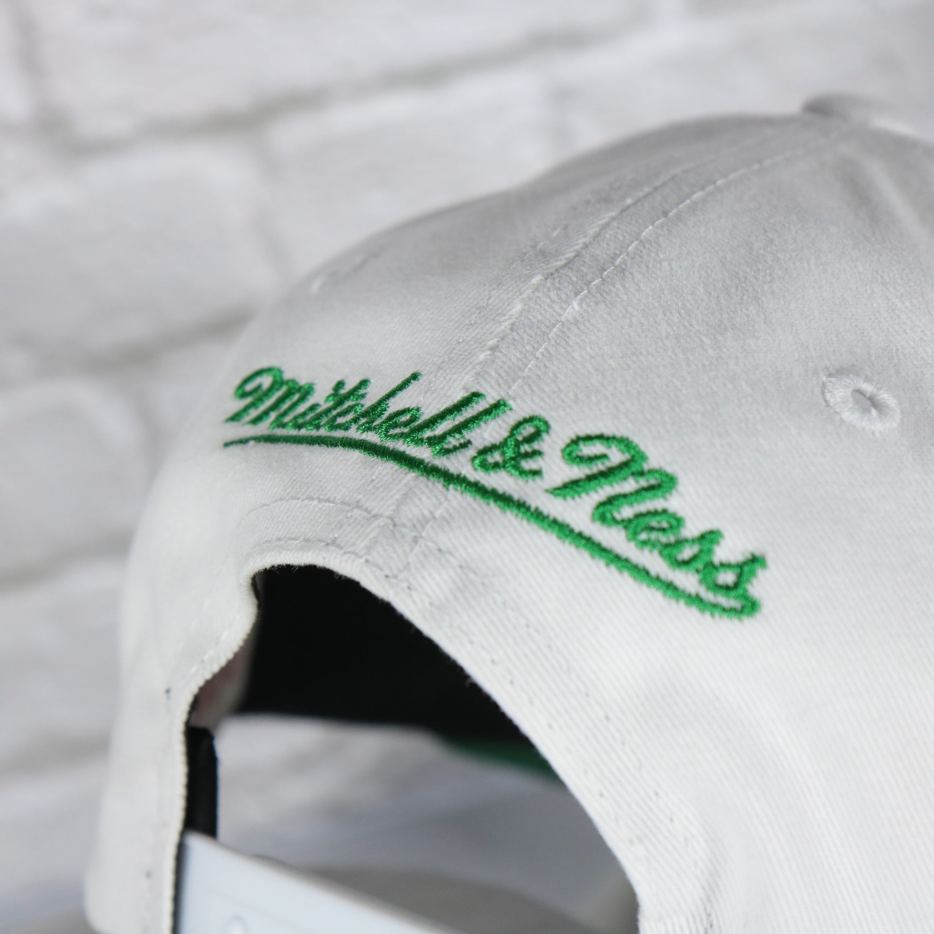 mitchell and ness logo on the Milwaukee Bucks NBA Hardwood Classics All in Pro Green Bottom | White Snapback Hat