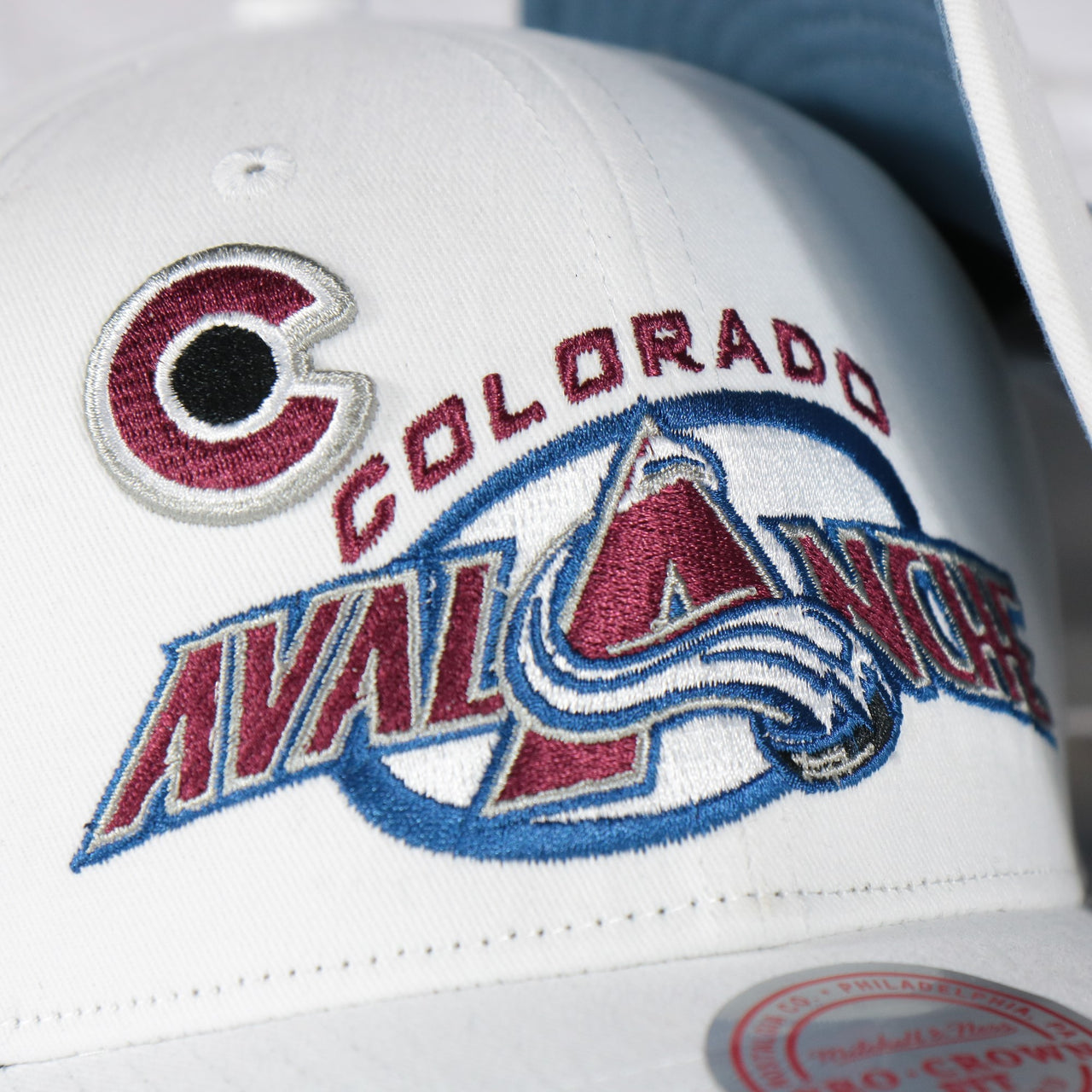 avalanche logo on the Colorado Avalanche NHL All in Pro Vintage Blue Bottom | White Snapback Hat