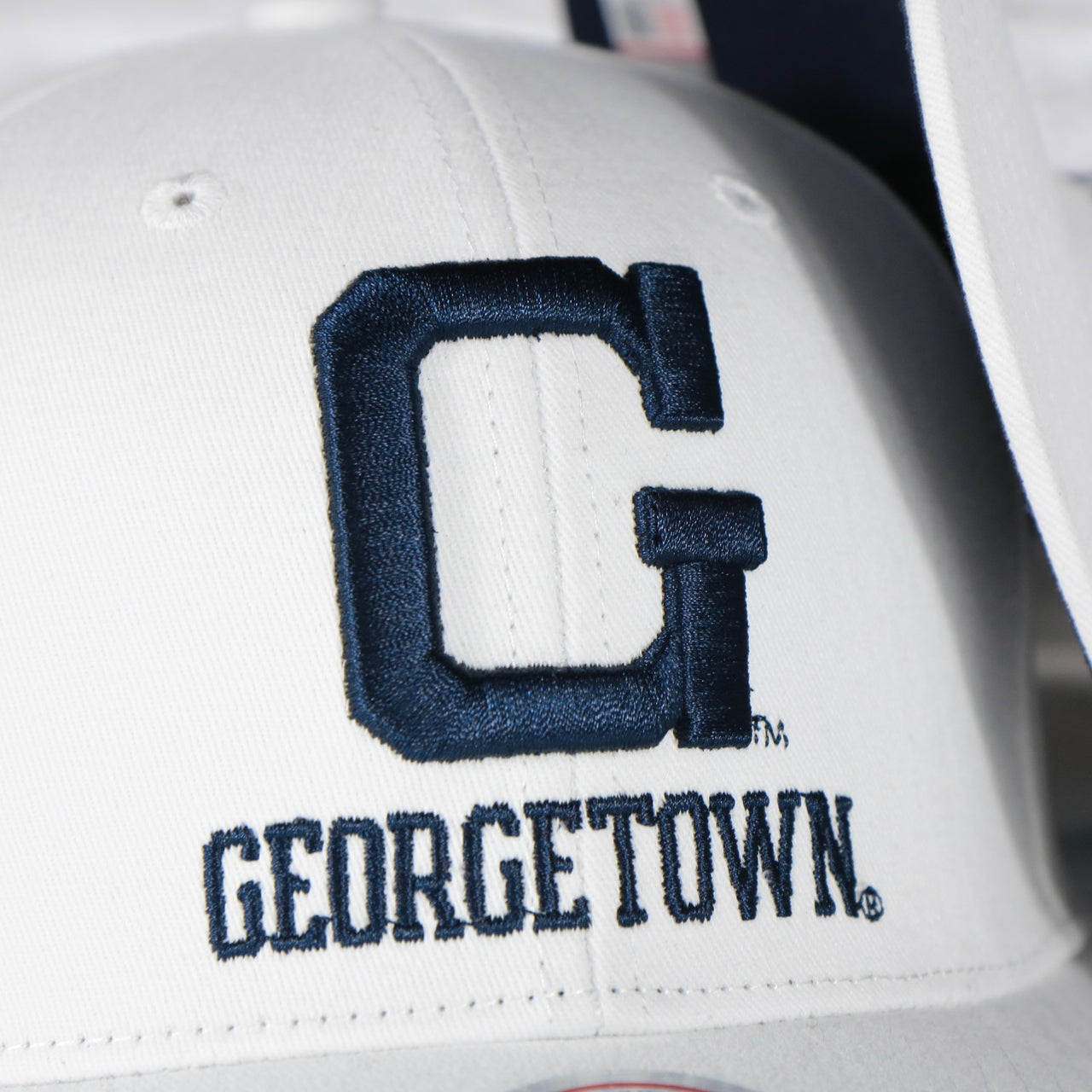hoyas  logo on the Georgetown Hoyas NCAA All in Pro Navy Bottom | White Snapback Hat