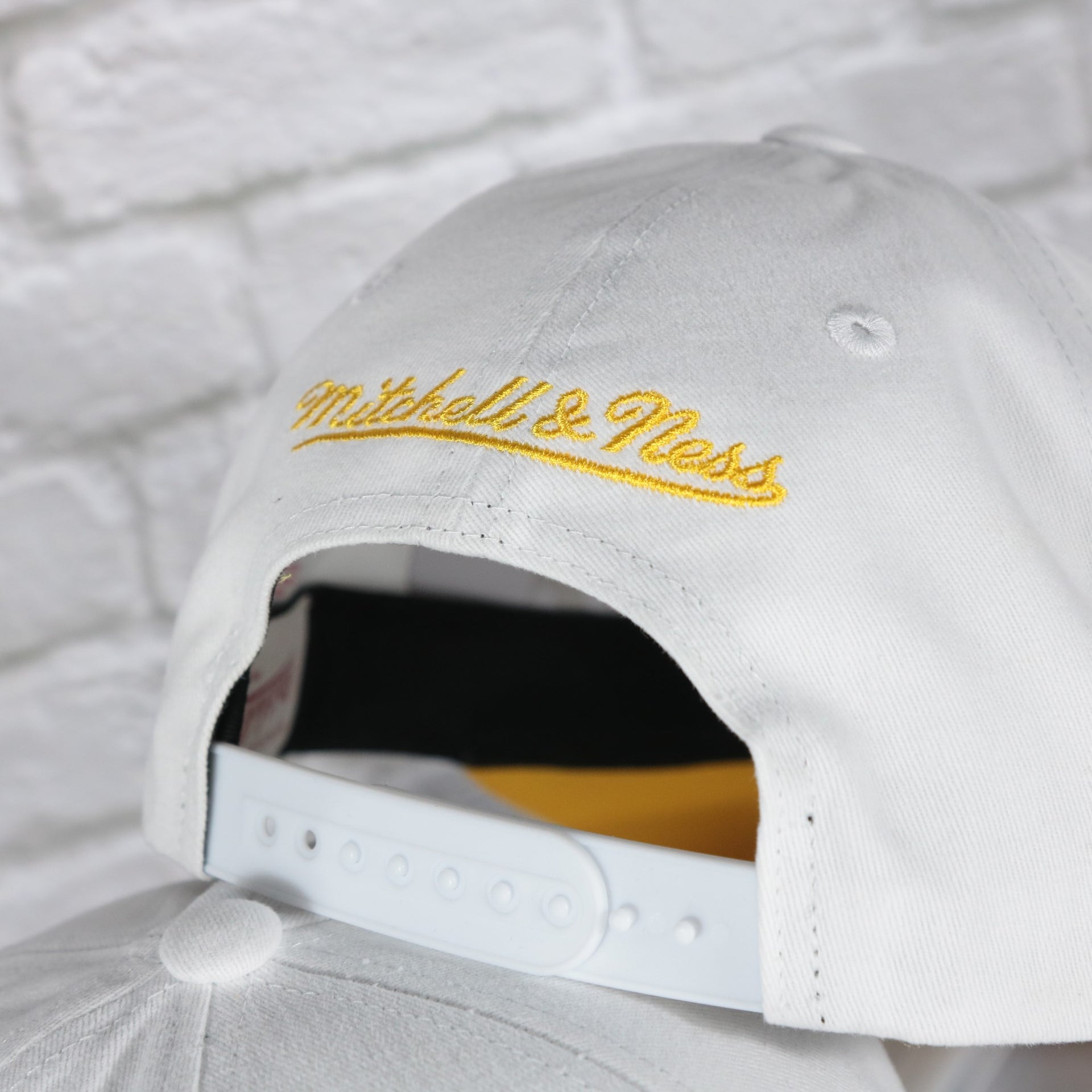 mitchell and ness logo on the Boston Bruins NHL All in Pro Yellow Bottom | White Snapback Hat