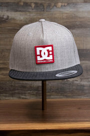 the 2-Tone Gray Snapback Skater Hat | DC Shoes Black Bottom Snap Back Cap has a dark brim and a pale grey tweed upper