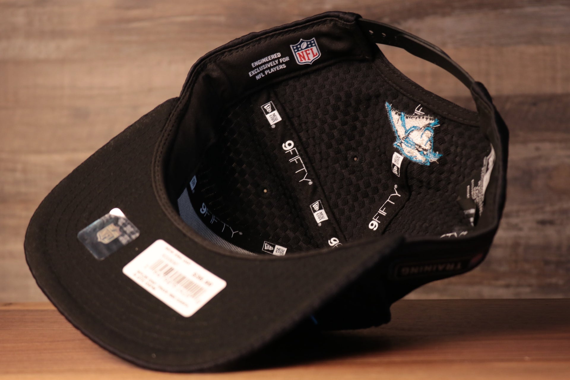 Panthers 2020 Training Camp Snapback Hat | Carolina Panthers 2020 On-Field Black Training Camp Snap Cap the underside of this panthers training cap is a stretchy material with sweatbands