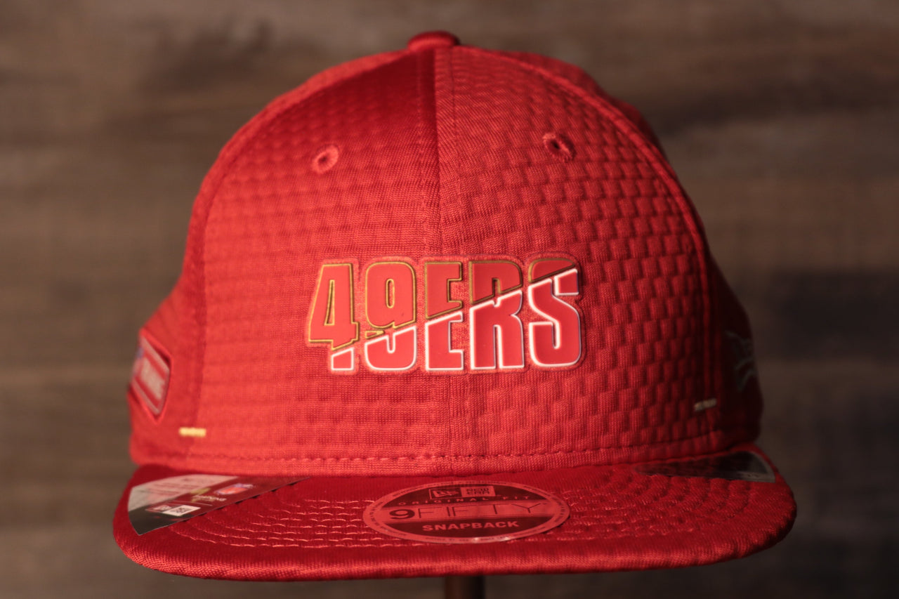 49ers 2020 Training Camp Snapback Hat | San Francisco 2020 On-Field Red Training Camp Snap Cap the front of this 49ers hat has the niners name on it