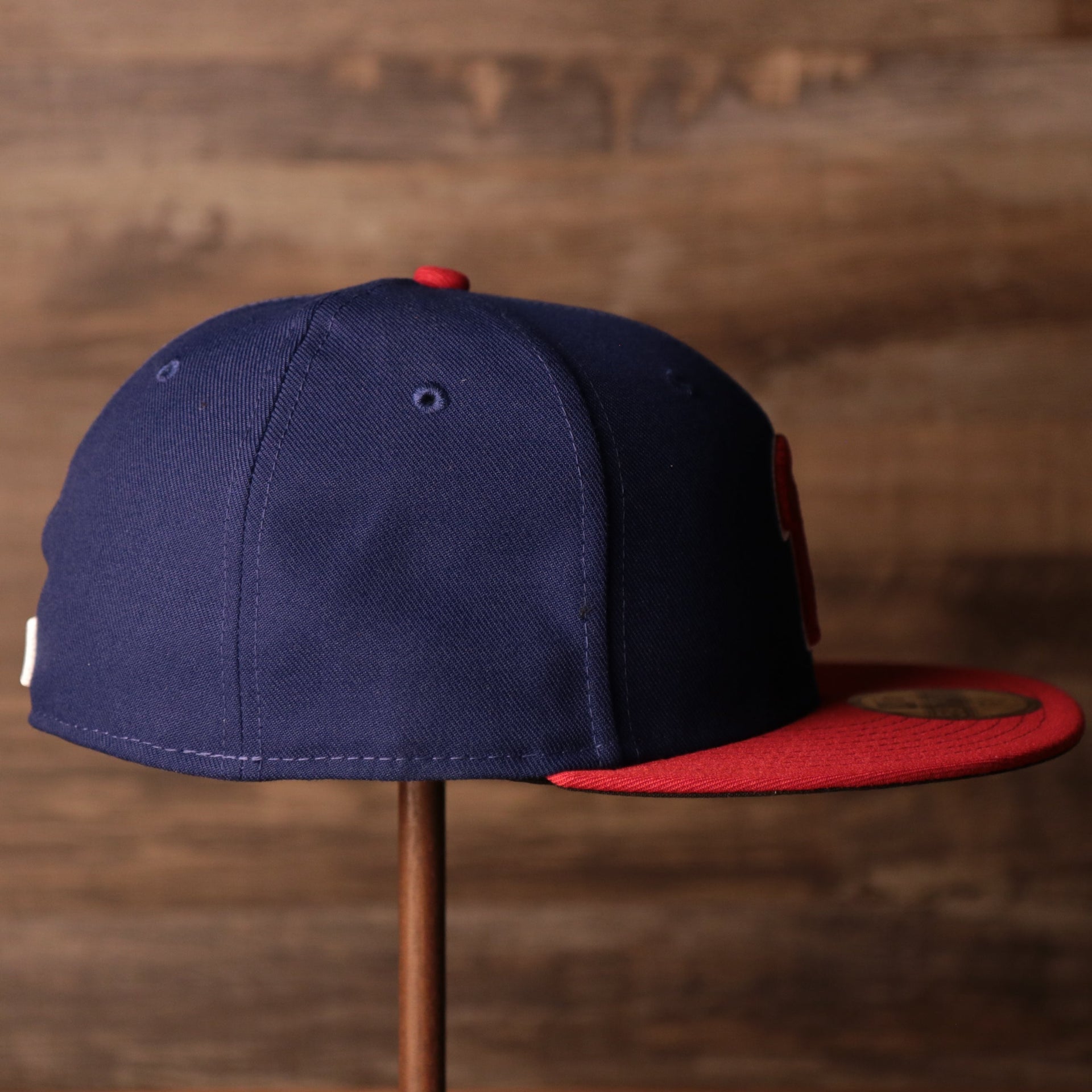 The wearer's right on the Philadelphia Phillies Blue on Red Game Authentic 59Fifty Fitted Cap
