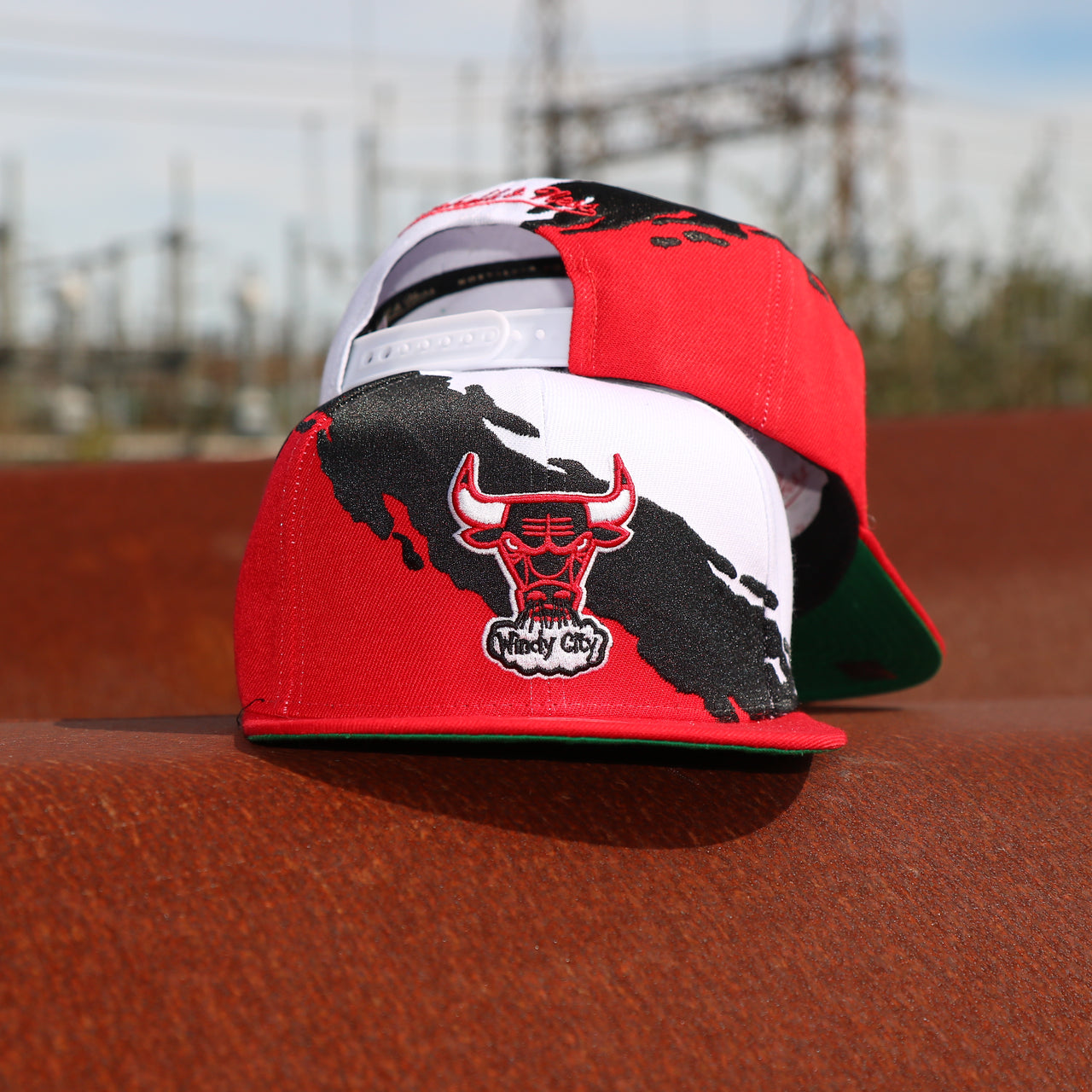 back and front of the Chicago Bulls Vintage Retro NBA Paintbrush Mitchell and Ness Snapback Hat | Red/White/Black