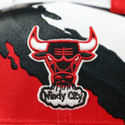 bulls logo on the front of the Chicago Bulls Vintage Retro NBA Paintbrush Mitchell and Ness Snapback Hat | Red/White/Black