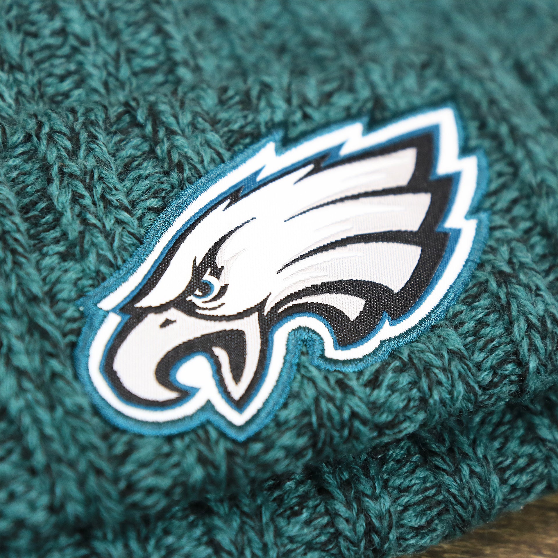 The Eagles Logo on the Women’s Philadelphia Eagles Midnight Green On Field Knit Winter Beanie | Green Winter Beanie