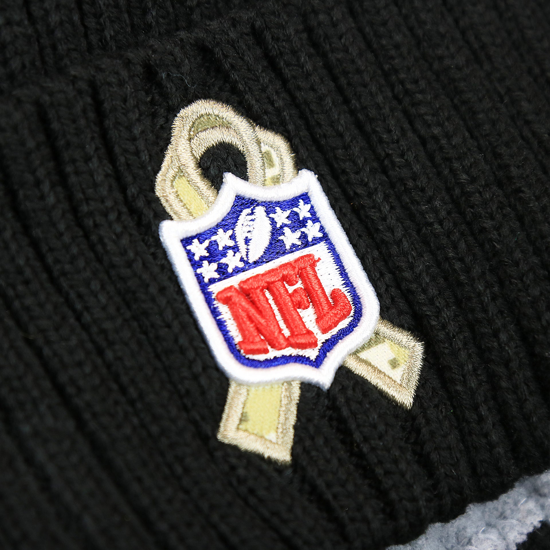 The Salute To Service NFL Ribbon on the Philadelphia Eagles Salute To Service On Field Cuffed Winter Beanie | Black Winter Beanie