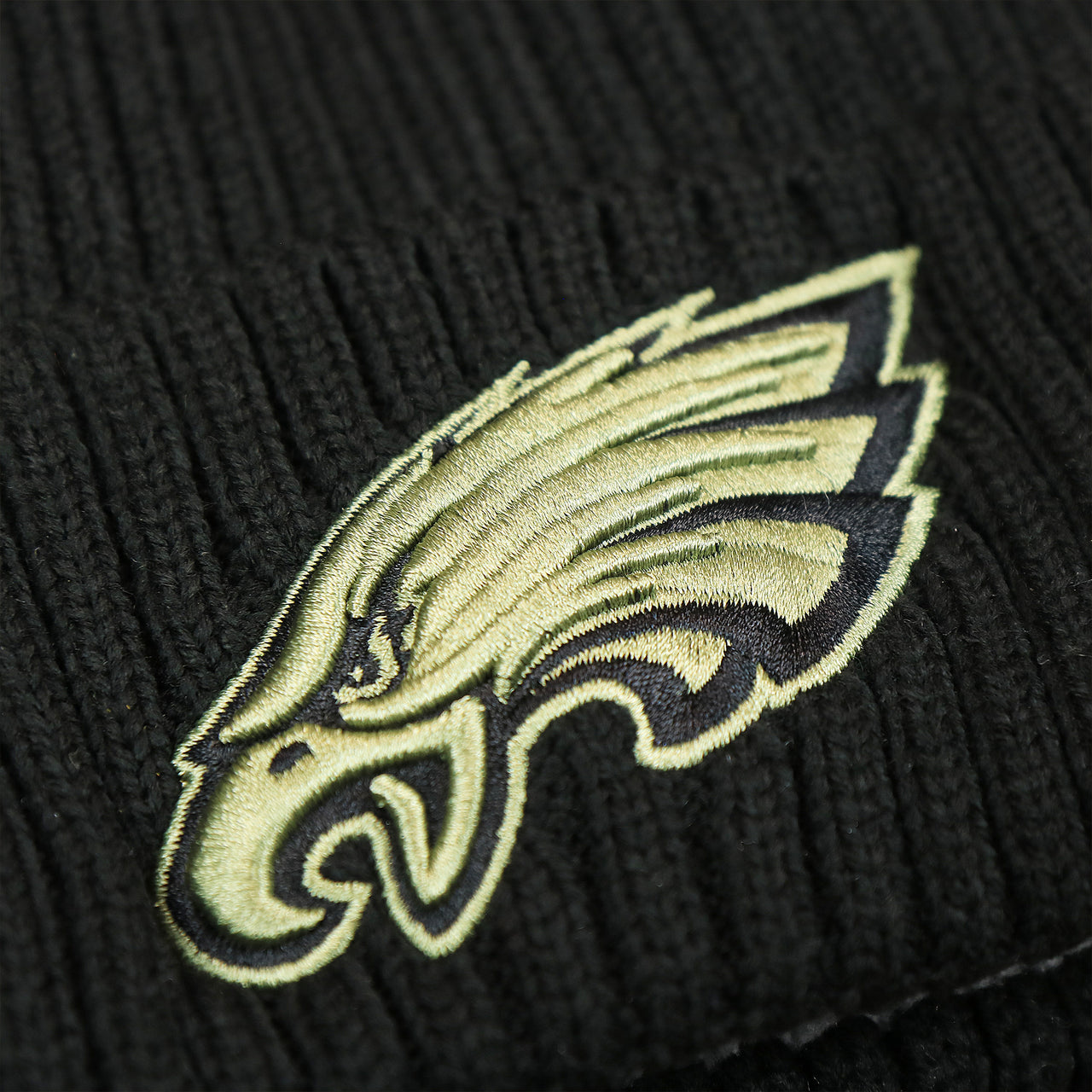 The Eagles Logo on the Philadelphia Eagles Salute To Service On Field Cuffed Winter Beanie | Black Winter Beanie