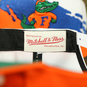 mitchell and ness logo on the back of the University of Florida Vintage Retro NCAA Paintbrush Mitchell and Ness Snapback Hat | Orange/Blue/White