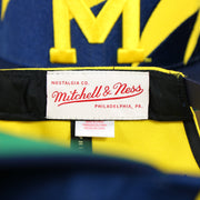 mitchell and ness tag on the University of Michigan Vintage Retro NCAA Sharktooth Mitchell and Ness Snapback Hat | Yellow/Navy Blue