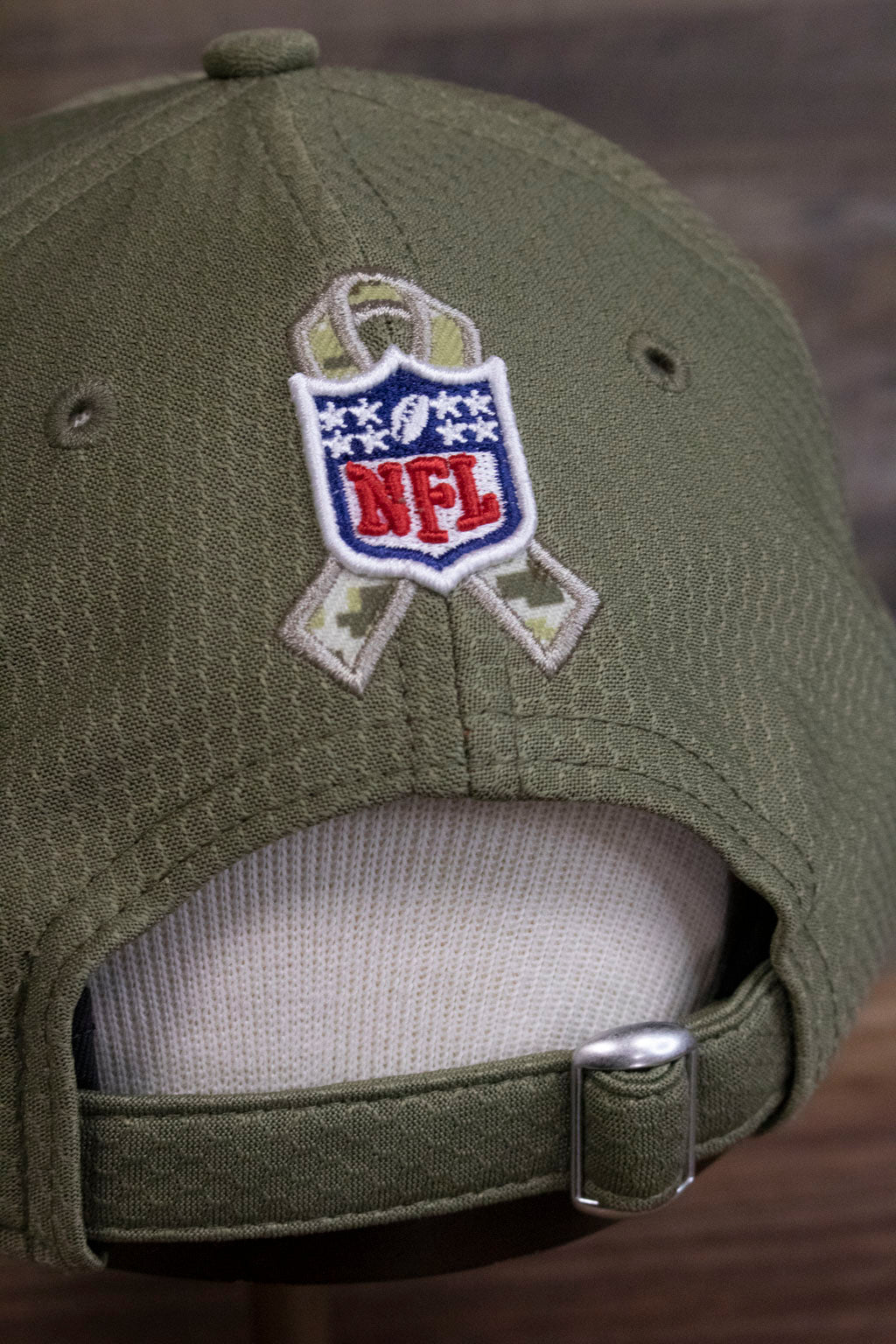 the NFL shield and camo Salute to Service ribbon on the Pittsburgh Steelers 2019 Salute To Service Dad Hat | Steelers On Field Olive Green Military Inspired Baseball Cap are made of raised embroidery