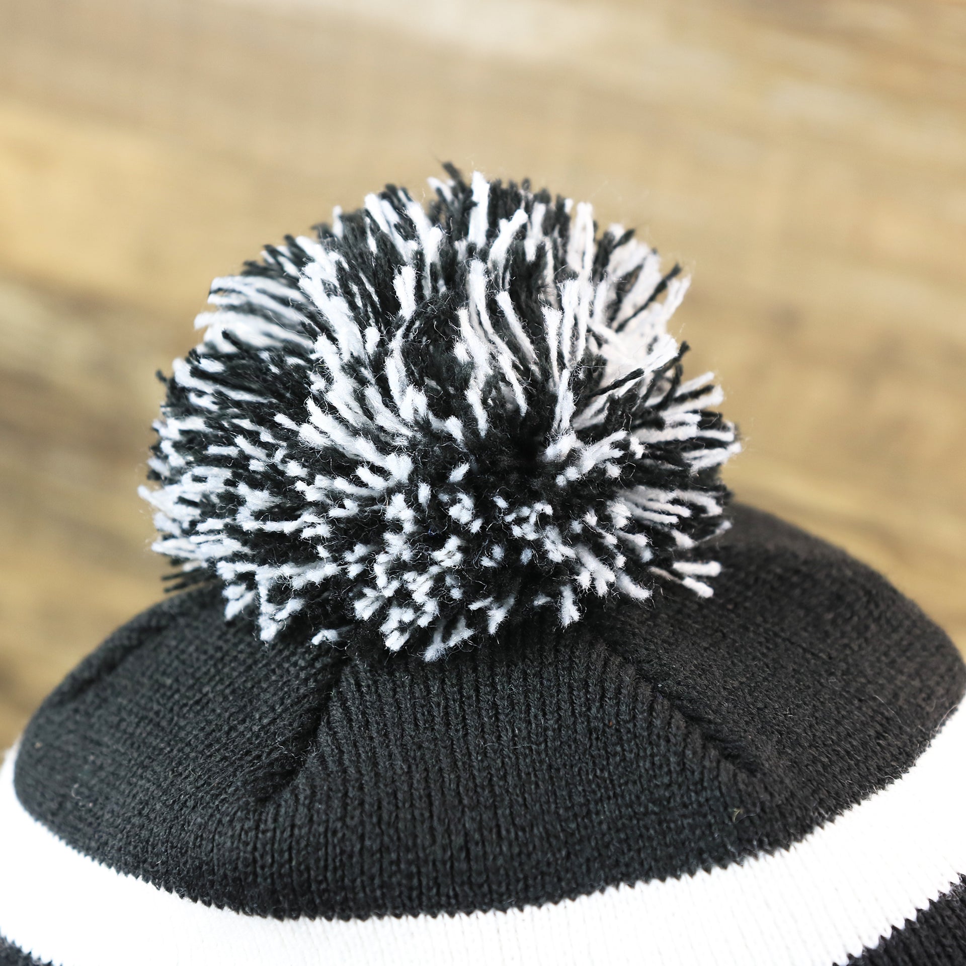 The Black And White Pom Pom on the Philadelphia Flyers Mascot Gritty Black And White Striped Cuffed Pom Pom Winter Beanie | Black Winter Beanie