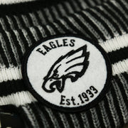 The Eagles Patch on the Philadelphia Eagles On Field Cuffed Winter Pom Pom Beanie | Black And White Winter Beanie