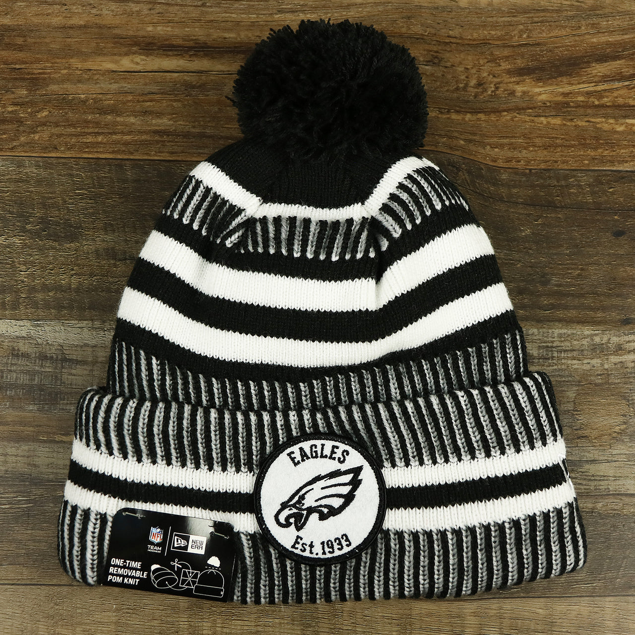 The front of the Philadelphia Eagles On Field Cuffed Winter Pom Pom Beanie | Black And White Winter Beanie