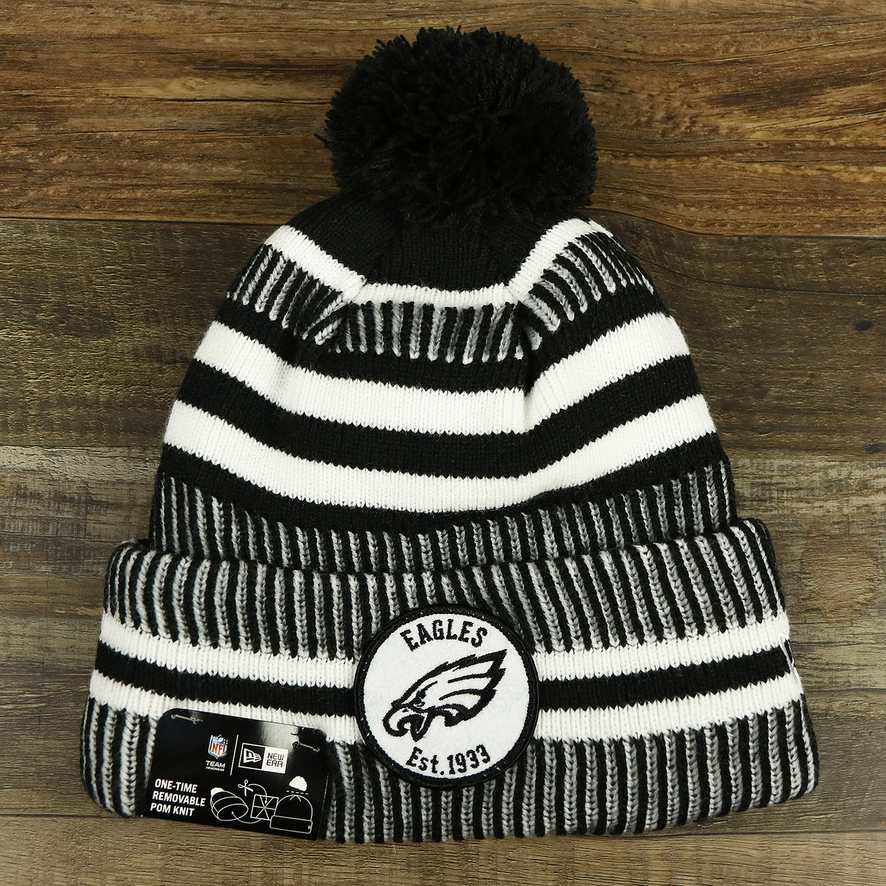 The front of the Philadelphia Eagles On Field Cuffed Winter Pom Pom Beanie | Black And White Winter Beanie