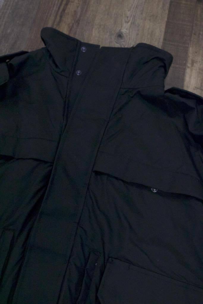 the Tactical Shell Jacket with Stow-Away Hood | Black Scotchlite Tacshell Jacket has a high collar