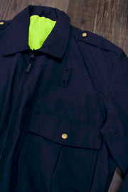 the Police Public Safety | Reversible Navy Blue Uniform Bomber Jacket | Waterproof Scotchlite Reflective Safety Green and Police Blue Rain Jacket has a high collar and neon green reverse side