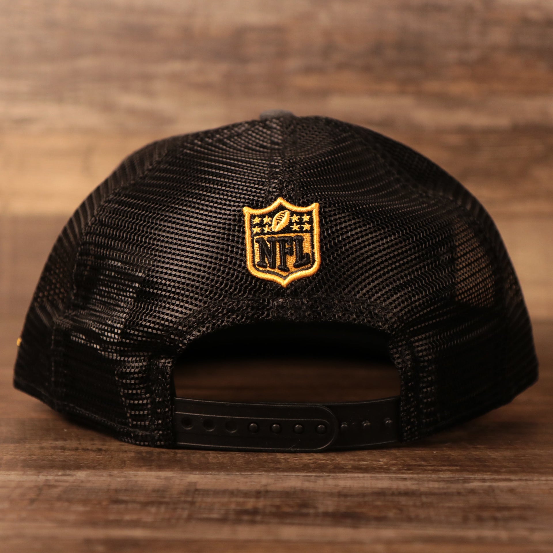 The NFL logo on the back side of the gray/black Steelers 2021 NFL draft cap.