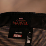 the movie logo is on the sweatband of this cap Captain Marvel Red Bottom Snapback | Captain Marvel Navy Trucker Red Bottom Snap Cap