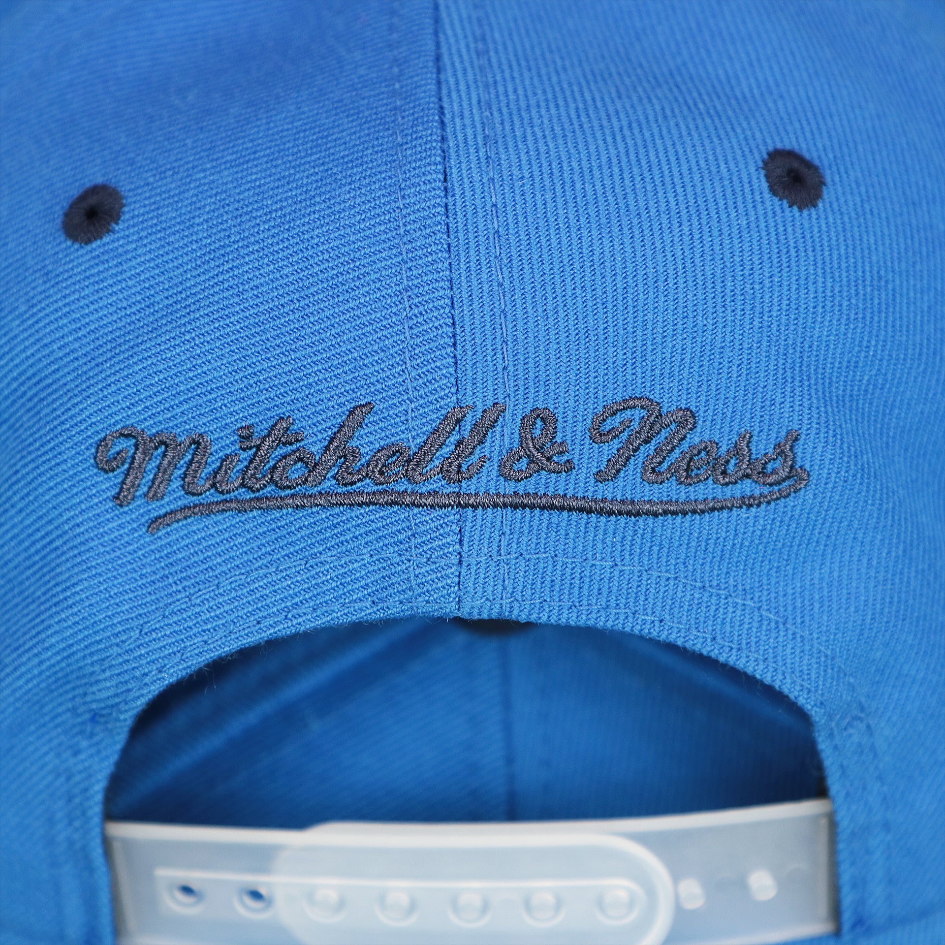 The Mitchell And Ness Wordmark on the Thunder Snapback Hat | Oklahoma City Thunder Reflective 2-Tone Snap Cap