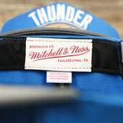 The Mitchell And Ness Tag on the Thunder Snapback Hat | Oklahoma City Thunder Reflective 2-Tone Snap Cap