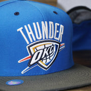 The thunder logo on the Thunder Snapback Hat | Oklahoma City Thunder Reflective 2-Tone Snap Cap