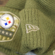 The New Era Logo on the Pittsburgh Steelers Salute To Service Ribbon Rubber Military Steelers Patch On Field NFL Beanie | Military Green Beanie