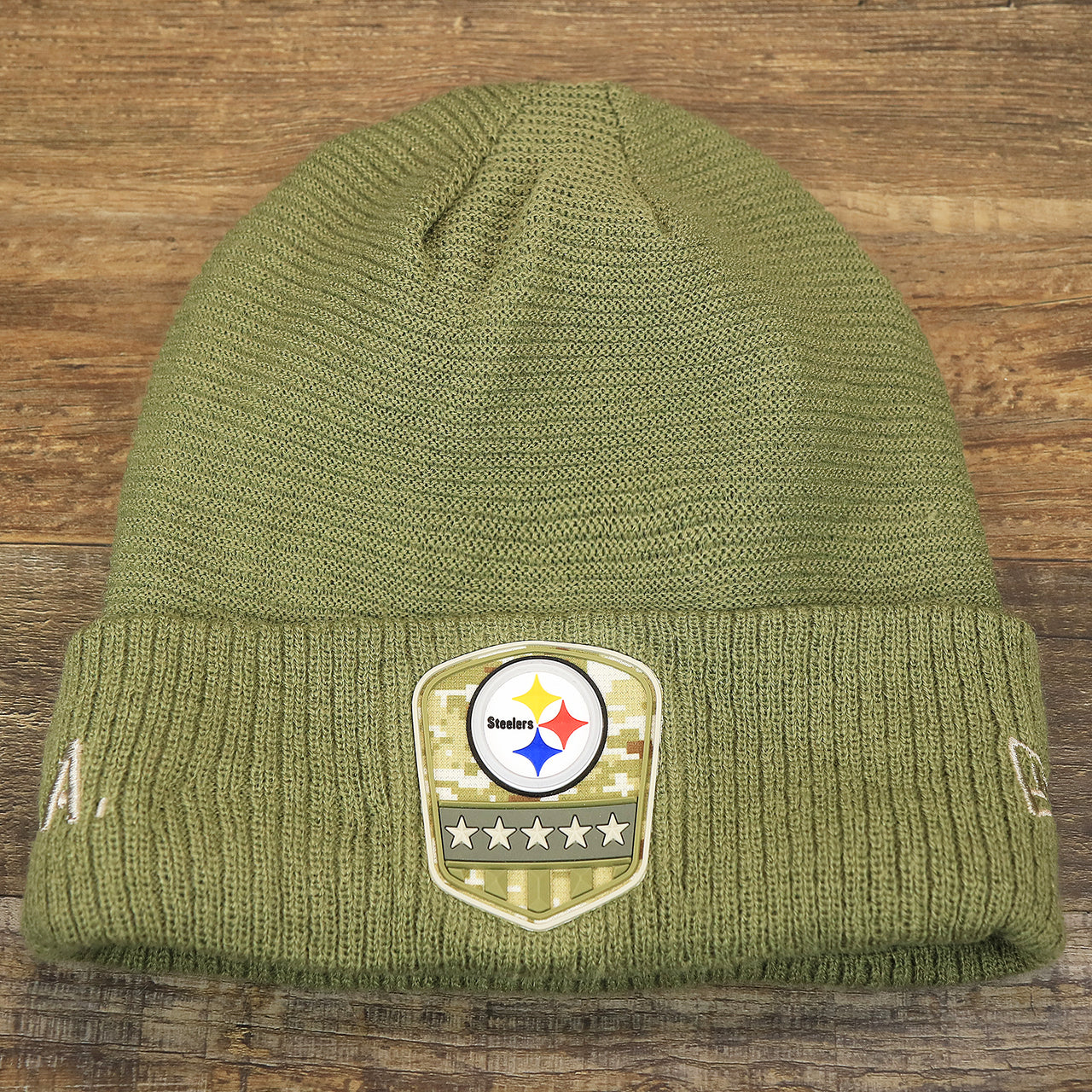 The front of the Pittsburgh Steelers Salute To Service Ribbon Rubber Military Steelers Patch On Field NFL Beanie | Military Green Beanie