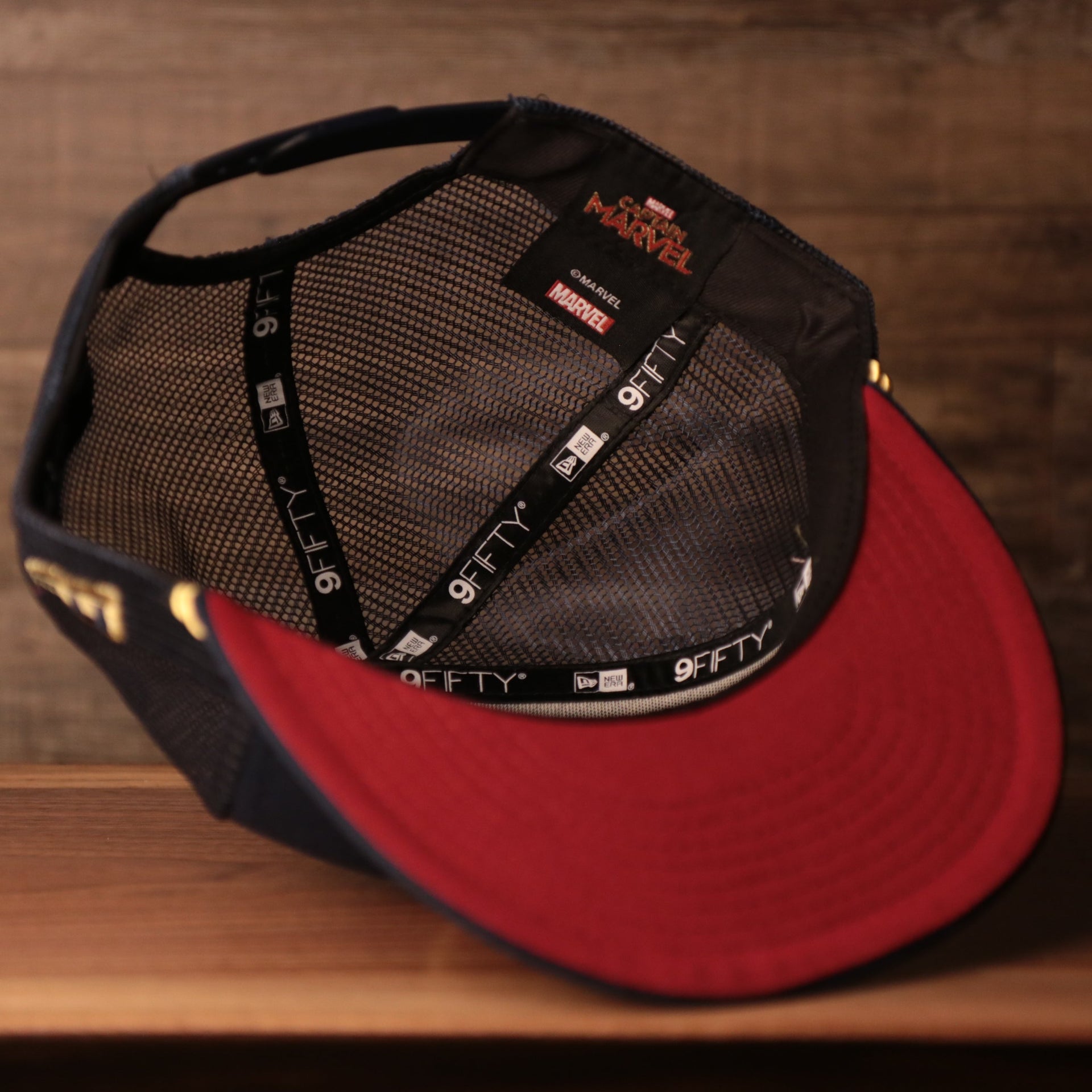 the sweatband on the inside of the snapback is black Captain Marvel Red Bottom Snapback | Captain Marvel Navy Trucker Red Bottom Snap Cap