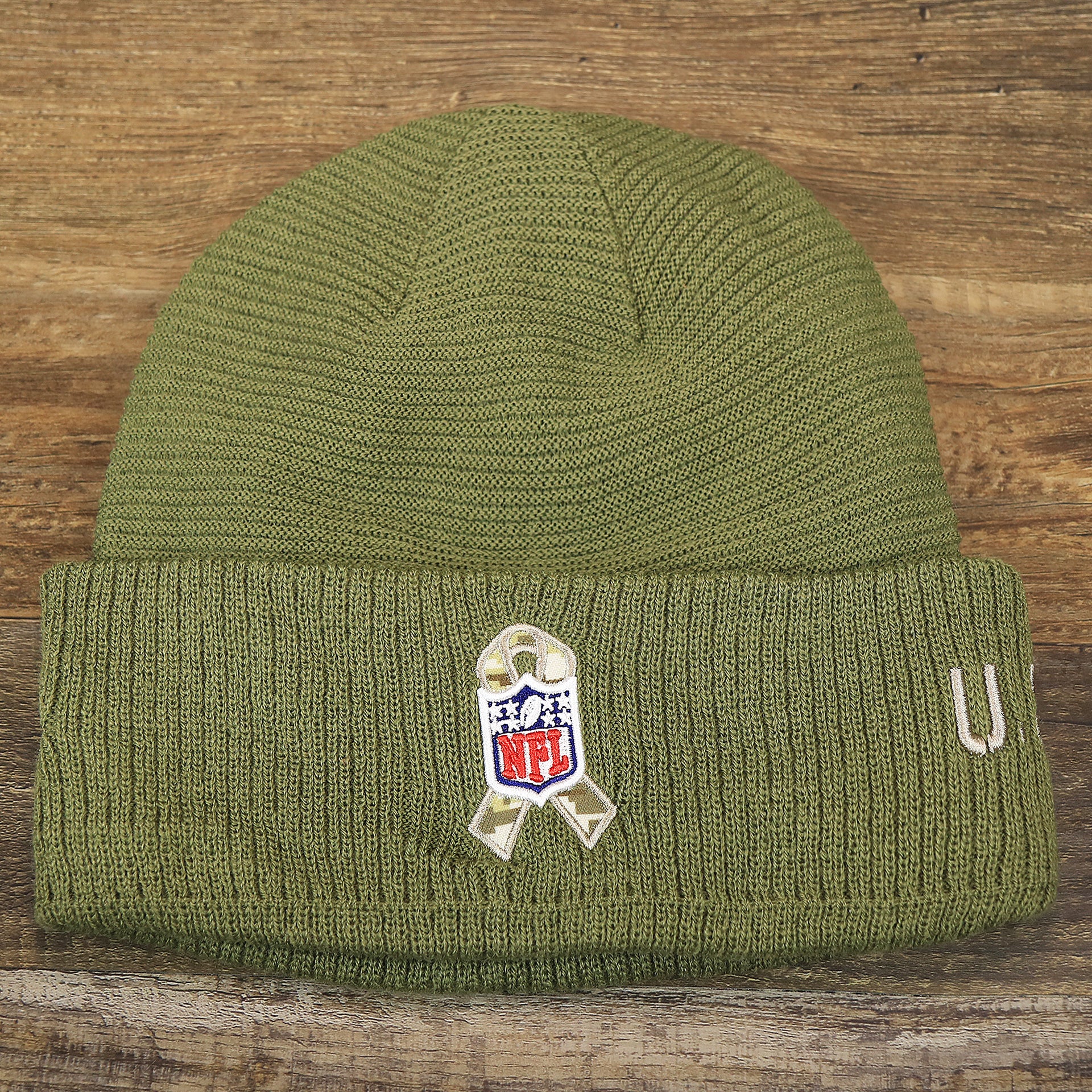 The backside of the New York Giants Salute To Service Ribbon Rubber Military Giants Patch On Field NFL Beanie | Military Green Beanie