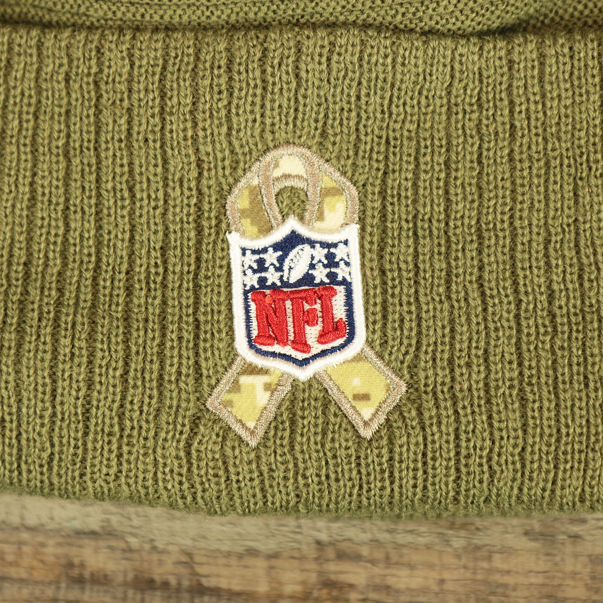 The NFL Salute To Service Ribbon on the Dallas Cowboys Salute To Service Ribbon Rubber Military Cowboys Patch On Field NFL Beanie | Military Green Beanie