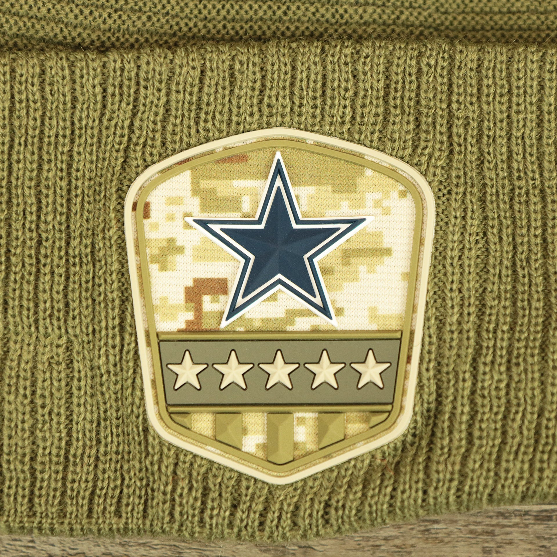 The Rubber Cowboys Logo Patch on the Dallas Cowboys Salute To Service Ribbon Rubber Military Cowboys Patch On Field NFL Beanie | Military Green Beanie