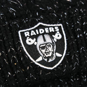 The Raiders Logo on the Women’s Las Vegas Raiders Reflective Silver Cuffed Pom Pom Winter Beanie | Black Winter Beanie